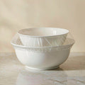 Disposable elastic bowl covers stretched over white ceramic bowls to keep food fresh
