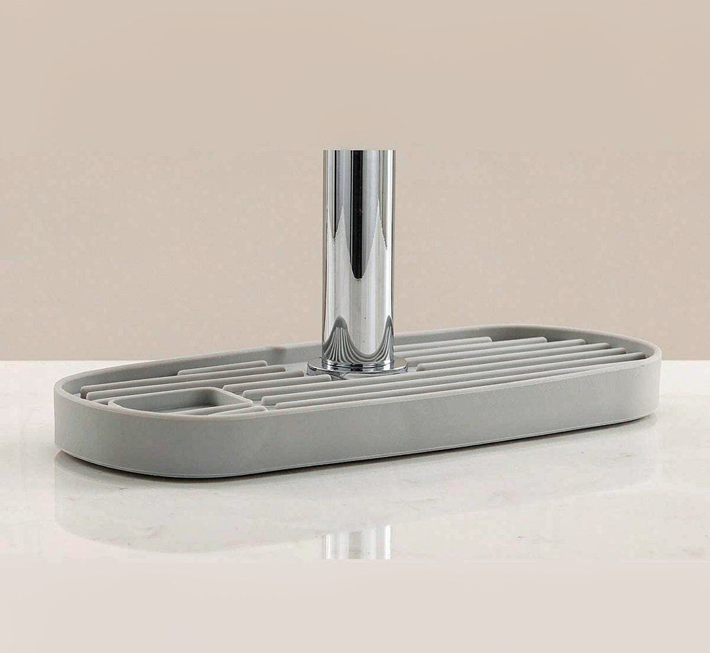 Silicone faucet splash guard mat with auto-drain and a soap slot for the kitchen sink