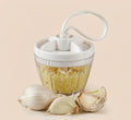 Mini manual garlic chopper with a pull cord and sealed container